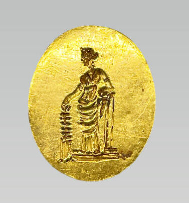 A birdseye view of an ovular gold ring inset with the image of a Grecian woman.